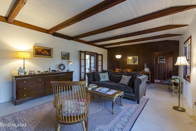2626 E 4th St, Tucson, AZ 85716 - living room with wood walls, beam ceiling, and light colored carpet