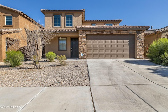 mediterranean / spanish-style house with stone siding, stucco siding, a tiled roof, concrete driveway, and an attached garage