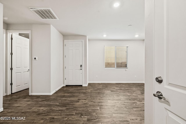 spare room featuring recessed lighting, baseboards, visible vents, and dark wood finished floors