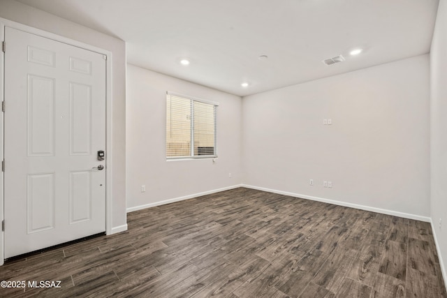 unfurnished room featuring visible vents, recessed lighting, dark wood-style flooring, and baseboards
