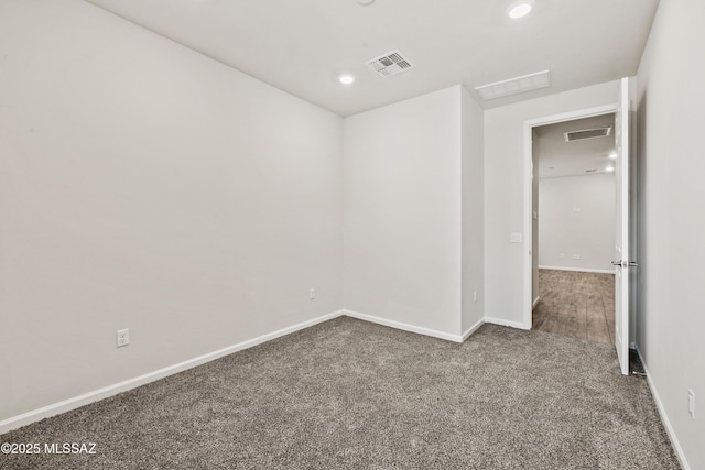 unfurnished room featuring recessed lighting, baseboards, visible vents, and dark colored carpet