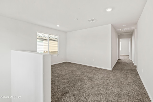 spare room featuring visible vents, recessed lighting, carpet, and baseboards