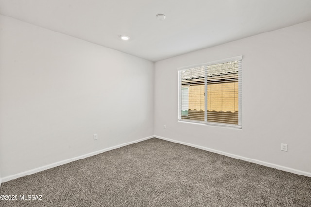 unfurnished room featuring dark colored carpet, recessed lighting, and baseboards