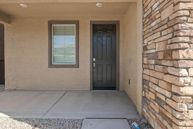 entrance to property with stucco siding