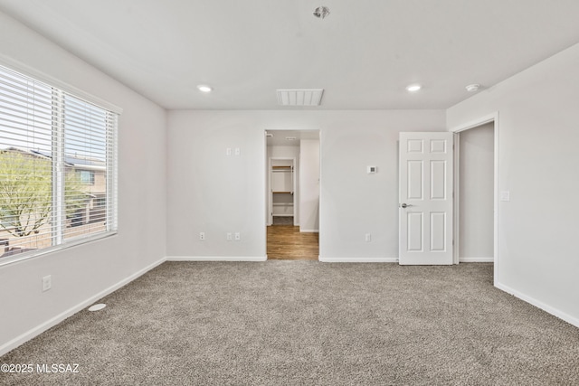unfurnished bedroom with carpet floors, recessed lighting, baseboards, and visible vents