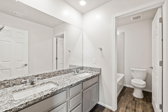 full bath featuring visible vents, a sink, wood finished floors, and toilet