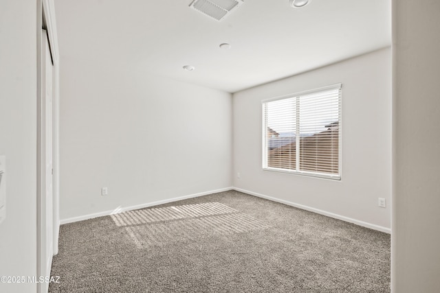 unfurnished room with baseboards, visible vents, and carpet