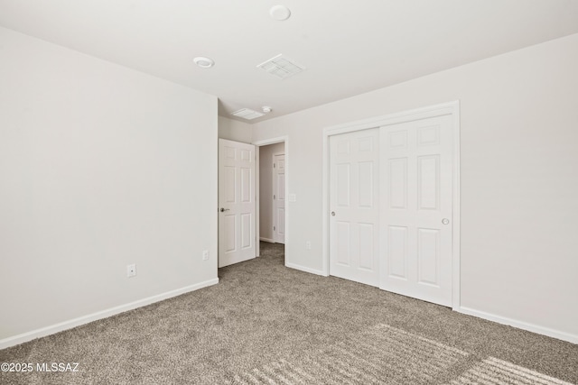 unfurnished bedroom featuring a closet, baseboards, carpet flooring, and visible vents