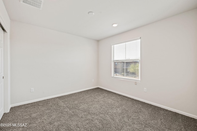 empty room featuring visible vents, recessed lighting, baseboards, and carpet floors