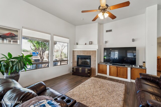 13960 E Placita Simpatica, Vail, AZ 85641 - kitchen with stainless steel appliances, a sink, light wood finished floors, a ceiling fan, and dark stone counters