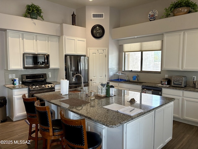 13960 E Placita Simpatica, Vail, AZ 85641 - kitchen with stainless steel appliances, white cabinets, backsplash, and a towering ceiling