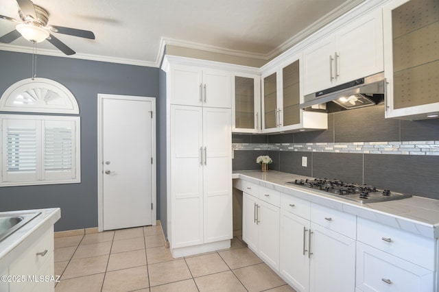 1025 N Perry Ave, Tucson, AZ 85705 - kitchen with stainless steel gas stovetop, under cabinet range hood, decorative backsplash, ceiling fan, and crown molding