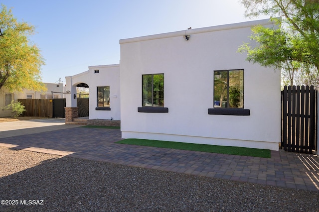 1025 N Perry Ave, Tucson, AZ 85705 - view of property exterior with a patio, stucco siding, and fence