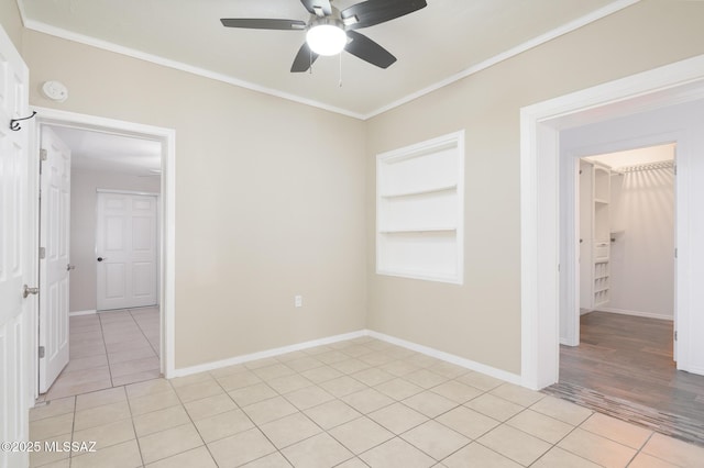 1025 N Perry Ave, Tucson, AZ 85705 - spare room featuring light tile patterned floors, baseboards, ornamental molding, a ceiling fan, and built in features