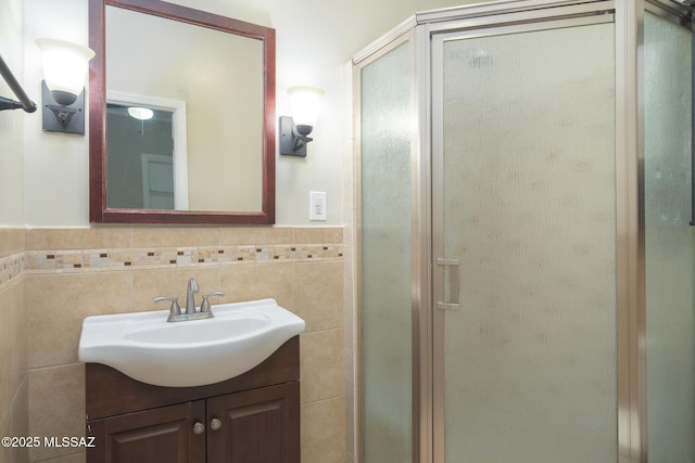 1025 N Perry Ave, Tucson, AZ 85705 - full bathroom with vanity, a shower stall, a wainscoted wall, and tile walls