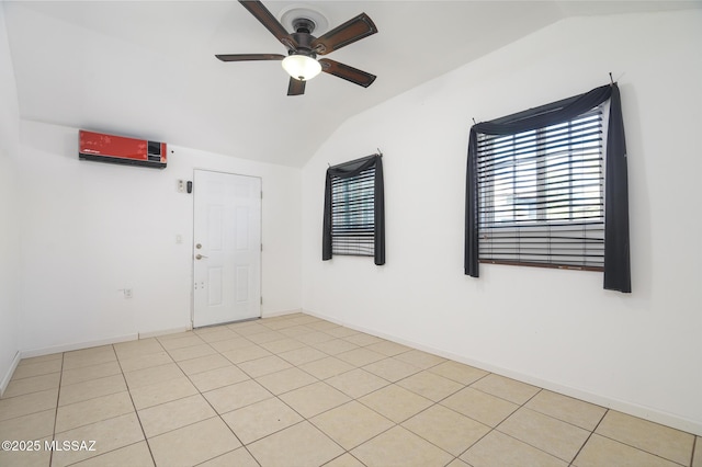 1025 N Perry Ave, Tucson, AZ 85705 - empty room featuring light tile patterned floors, a ceiling fan, vaulted ceiling, and baseboards