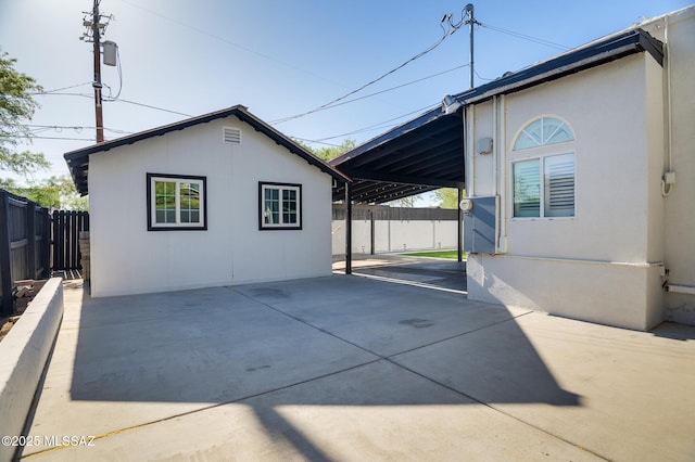 1025 N Perry Ave, Tucson, AZ 85705 - view of home's exterior featuring a patio, fence, and an attached carport