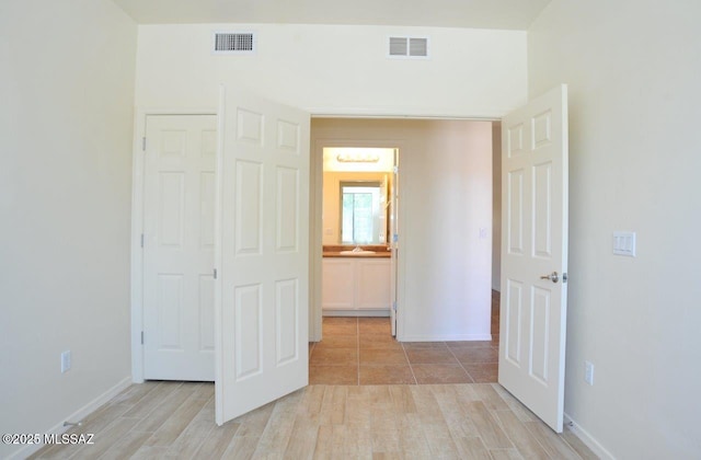8573 N Western Juniper Ter, Tucson, AZ 85743 - unfurnished bedroom with baseboards, visible vents, and light wood finished floors