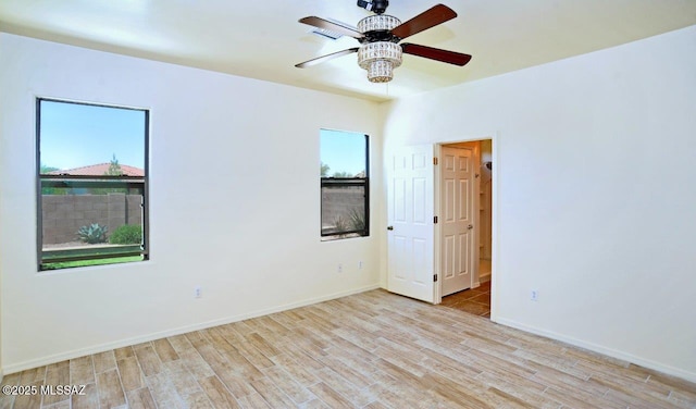8573 N Western Juniper Ter, Tucson, AZ 85743 - empty room featuring a ceiling fan, baseboards, and wood finished floors