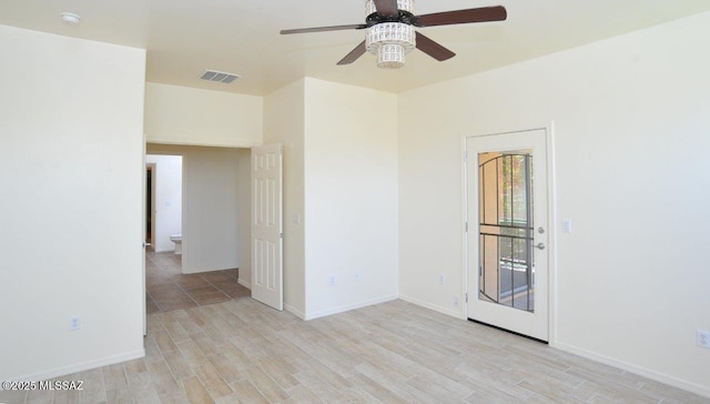 8573 N Western Juniper Ter, Tucson, AZ 85743 - unfurnished room featuring baseboards, a ceiling fan, wood finished floors, and visible vents