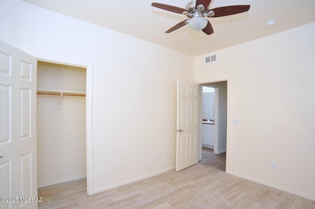 8573 N Western Juniper Ter, Tucson, AZ 85743 - unfurnished bedroom with ceiling fan, baseboards, light wood-type flooring, visible vents, and a closet