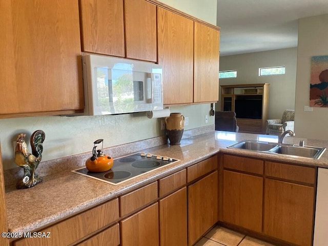 1040 W Stargazer Pl, Oro Valley, AZ 85737 - kitchen with white microwave, black electric cooktop, a sink, and light countertops