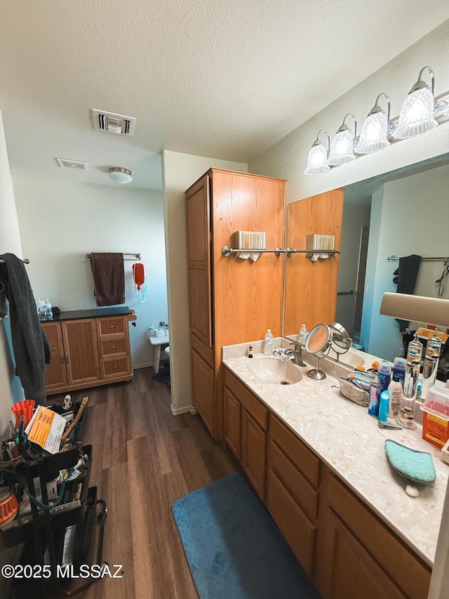 2692 W Dove Ln, Thatcher, AZ 85552 - bathroom featuring wood finished floors, a textured ceiling, and vanity