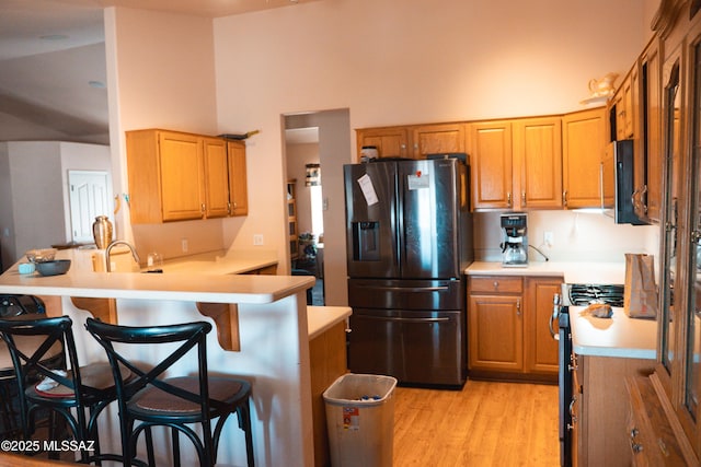 2692 W Dove Ln, Thatcher, AZ 85552 - kitchen with appliances with stainless steel finishes, light countertops, a peninsula, a towering ceiling, and a breakfast bar area