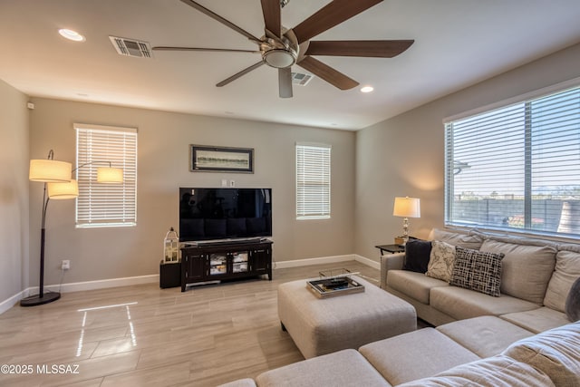 12100 E Ryscott Cir, Vail, AZ 85641 - living room with baseboards, a wealth of natural light, a ceiling fan, and visible vents