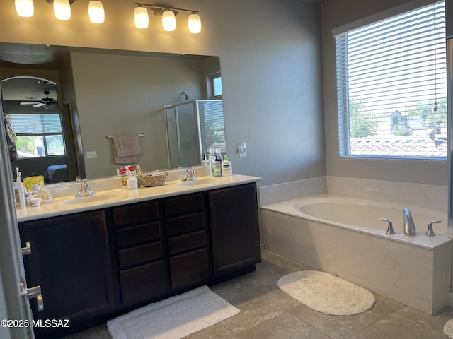 ensuite bathroom featuring ensuite bathroom, a sink, and a healthy amount of sunlight