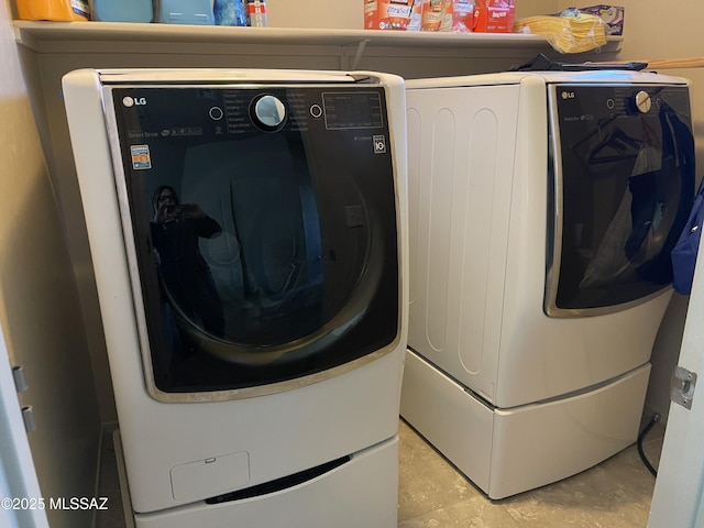 laundry area featuring washer and dryer and laundry area