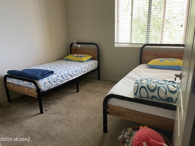 bedroom featuring carpet flooring and baseboards