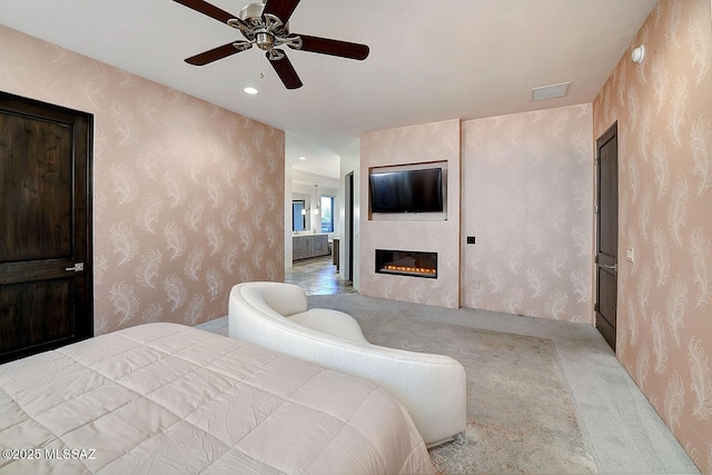 carpeted bedroom with recessed lighting, a large fireplace, a ceiling fan, visible vents, and wallpapered walls