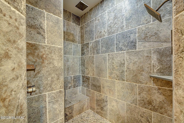 interior details with a tile shower