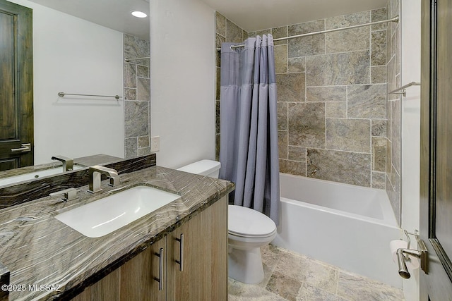 full bathroom with stone finish floor, vanity, toilet, and shower / bath combo