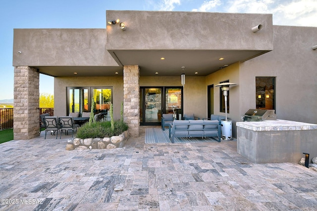 view of patio / terrace with outdoor lounge area, an outdoor kitchen, and area for grilling