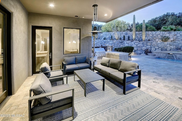 view of patio / terrace featuring an outdoor living space, an outdoor kitchen, and grilling area