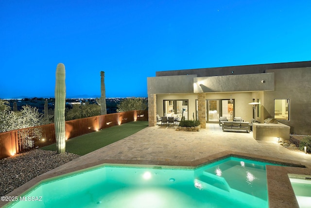 rear view of house with an outdoor living space, a fenced backyard, stucco siding, a fenced in pool, and a patio area