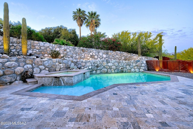 view of swimming pool with a fenced backyard, a patio area, an in ground hot tub, and a fenced in pool