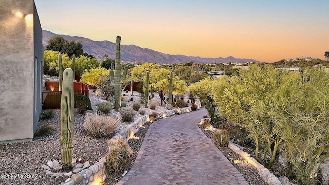 surrounding community featuring a mountain view and fence