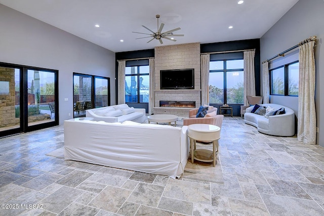 living area featuring recessed lighting, stone tile floors, and ceiling fan