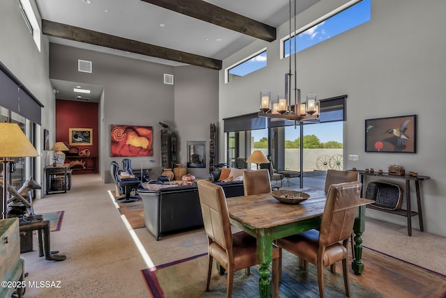 dining room featuring a chandelier, visible vents, beam ceiling, and a towering ceiling