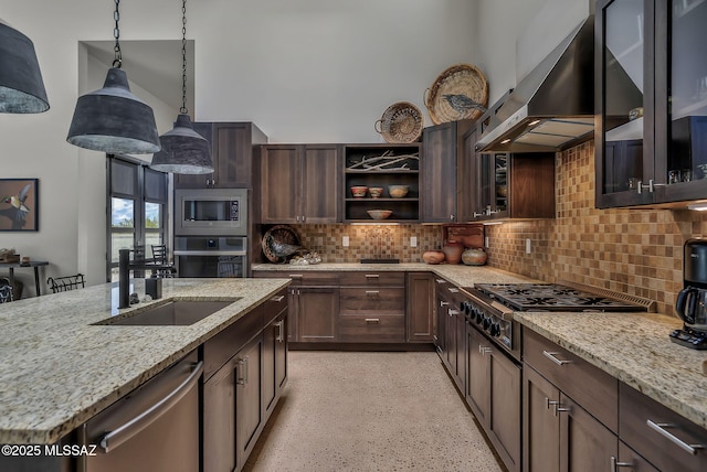 kitchen featuring decorative backsplash, dark brown cabinetry, pendant lighting, stainless steel appliances, and extractor fan