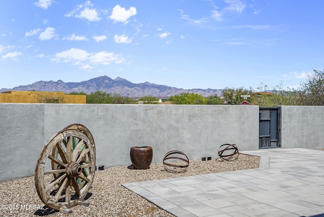 view of patio / terrace featuring a gate and a mountain view