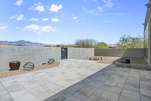 view of patio / terrace featuring a fenced backyard and a mountain view