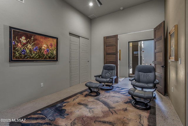 sitting room with a towering ceiling