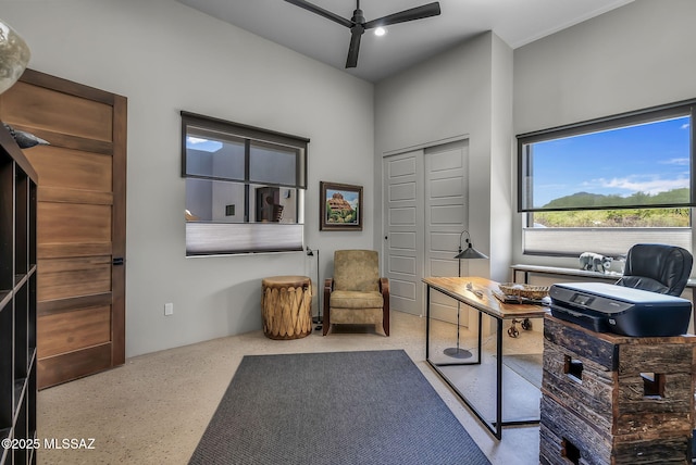 office area with a ceiling fan and speckled floor