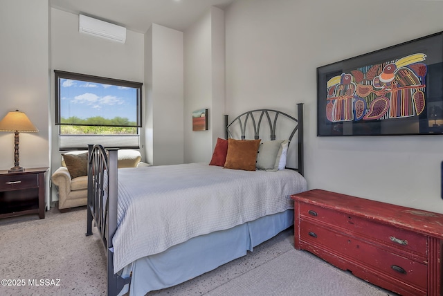 bedroom with speckled floor and a wall mounted air conditioner