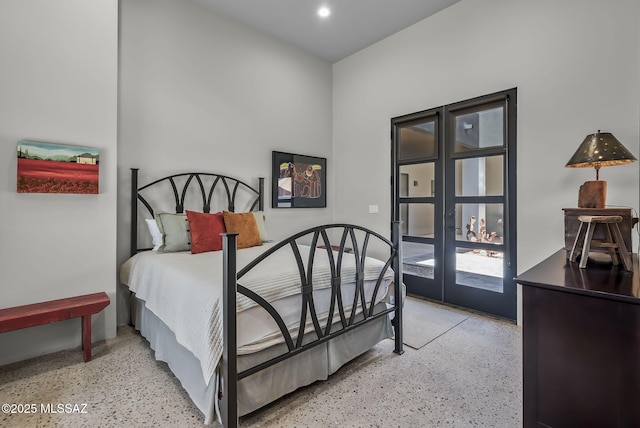bedroom with light speckled floor, french doors, and recessed lighting