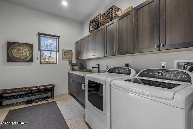 washroom featuring washing machine and dryer and cabinet space